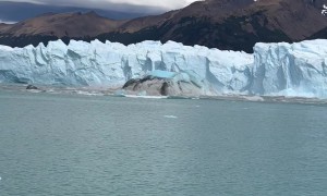 Sightseers Watch Iceberg Emerge From the Perito Moreno Glacier