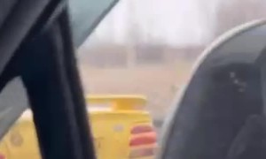 Convertible With Its Top Down in a Freezing Rain Storm