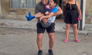 Boy Smiles Big While Playing Jump Rope With Dad