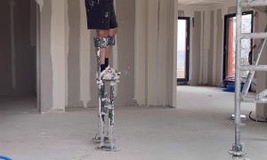 Worker on Stilts Shows How to Pick up Dropped Tool
