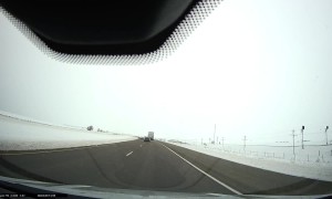 Passing Car Hits Ice and Rolls Into Ditch