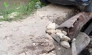 Car Safely Crosses Precarious Bridge