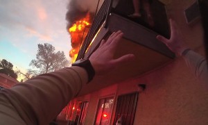 Police Officer Climbs on Dumpster to Rescue Woman Trapped on Balcony