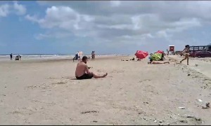 Man Falls Trying to Pass Soccer Ball at the Beach