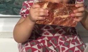 Girl Sneakily Enjoys Meat From the Freezer