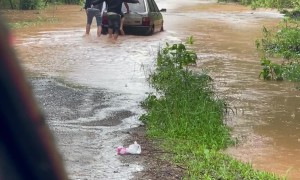 Men Push Car Through Flooded Street