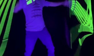 Man Practices With Glow in the Dark Whips At Night