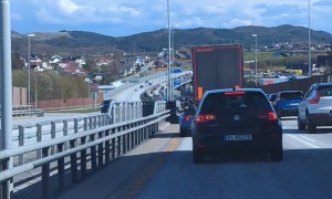Person Drives Mobility Scooter Along Busy Roadway