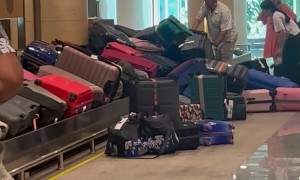 Suitcases Pile Up at Baggage Claim