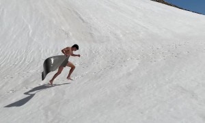 Gliding Down Snowy Slope Into Mountain Water