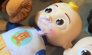 Toddler Tries to Feed Dolls Yogurt