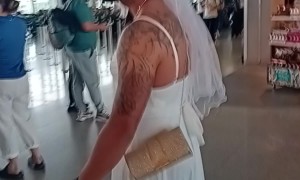 Man Walks Through Airport In Wedding Dress