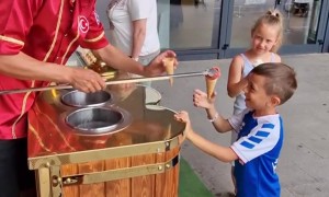 Ice Cream Vendor Plays Game With Young Customer