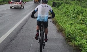 Cyclist Passed By Giant Wind Turbine Blade