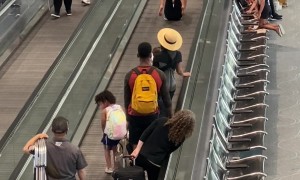 Travelers Have Fun on Moving Walkway at Denver Airport