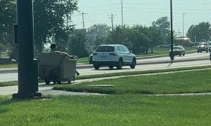Man Rides Motorized Recliner on Sidewalk