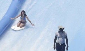 Surf Pool Attendant Is Prepared For Woman's Wipeout