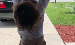 Little Boy Hangs on to Opening Garage Door