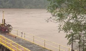 Pontoon Boat Goes Over Flooded Dam in Virginia