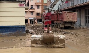 Excavator Operator Uses Refrigerator As Broom During Cleanup Efforts