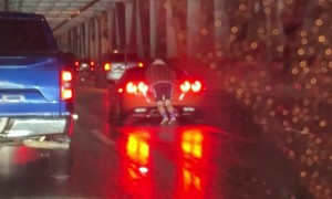 Man Hangs From Back of Moving Corvette