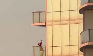 Grinch Dances on High-Rise Balcony