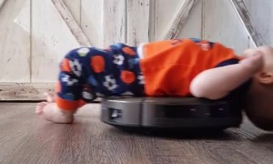 Son Relaxes On Robot Vacuum