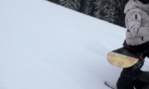 Couple Sit And Ski Down Slope