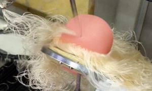 Machinery Puts Eyes And Hair On Dolls