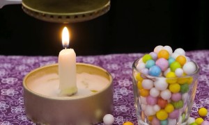 Green Foam Bead Melts Over Candle Flame
