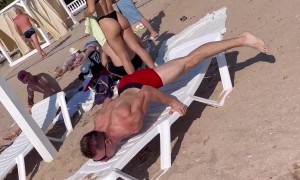 Man Demonstrates Muscled Balance On Beach Chair