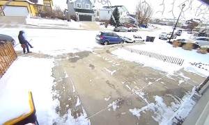 Kid slips on ice while carrying a shovel
