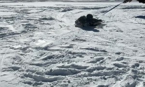 Snow revelers craft makeshift ride with an excavator and cart top