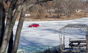 Cars Drive Down Frozen Fox River