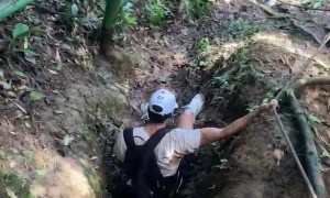 Man Feeling Goofy Jumps Into Muddy Hole