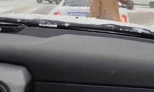 Man Clears Off Back Window Of Canadian Police Cruiser