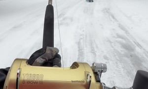Woman Goes Sledding With Boogie Board And Fishing Pole