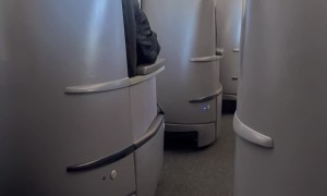 Airplane Passenger Exercises in Her Seat