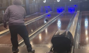 Player Throws Bowling Ball Across Lanes