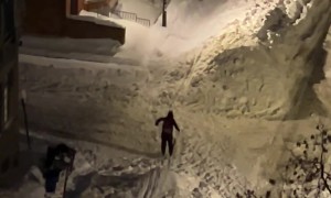 People Skiing on City Street After a Snowstorm