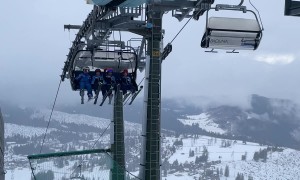 Young Skiers Sing On Chairlift