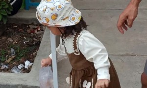 Toddler Carefully Moves Fish Around A Pole
