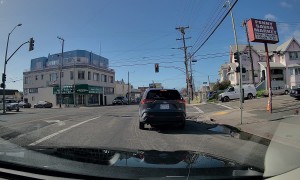 Backward Driver Speeds Through Red Light