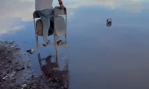 Man Uses Folding Chairs To Cross Water