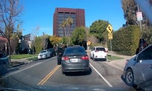 Woman Throws Drink On Car Behind Her