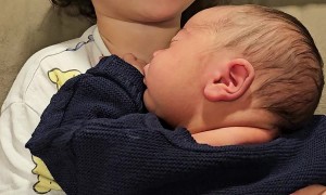 Toddler Protective While Cuddling With Baby Brother