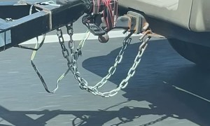 Driver Straps Trailer Securely To Truck