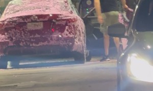 Man Washes Car Interior With Hose