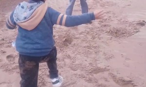 Two Kids Tumble Downhill