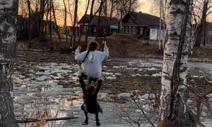 Village Girls Play On Rope Swing Over Water